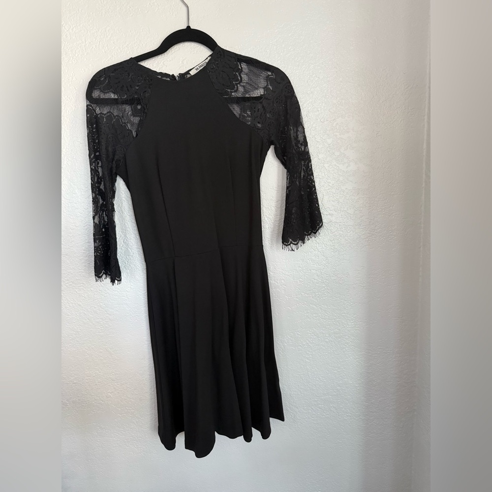 Black midi length dress with lace sleeves and back